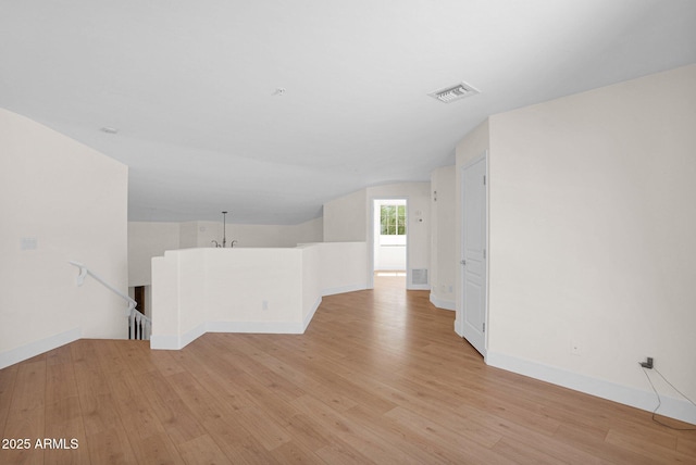 13914 E Laurel Ln, Scottsdale, AZ 85259 - unfurnished room with baseboards, vaulted ceiling, visible vents, and light wood-type flooring