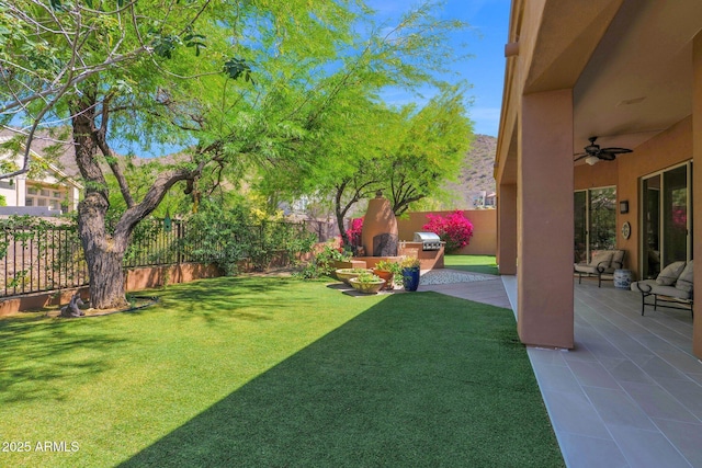 13914 E Laurel Ln, Scottsdale, AZ 85259 - view of yard featuring a fenced backyard, a ceiling fan, and a patio