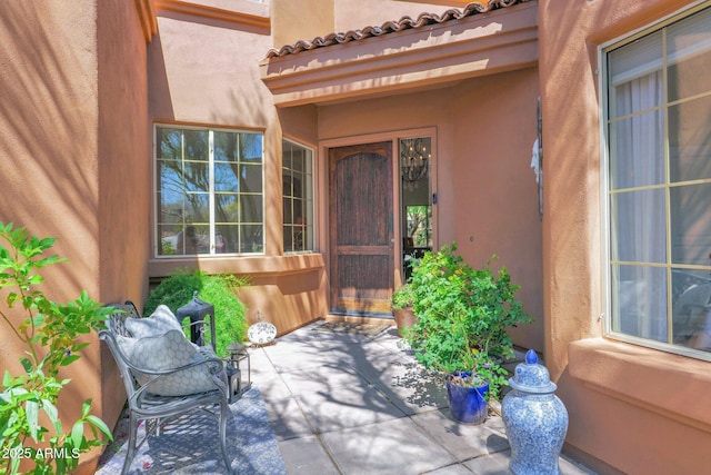 13914 E Laurel Ln, Scottsdale, AZ 85259 - property entrance featuring a tiled roof, a patio, and stucco siding