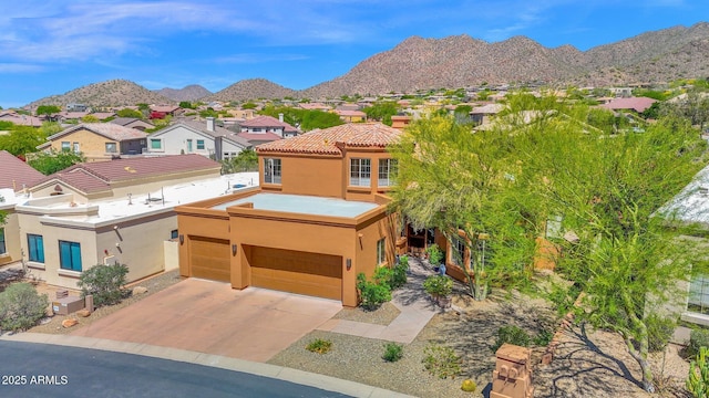 13914 E Laurel Ln, Scottsdale, AZ 85259 - view of front of home with stucco siding, a mountain view, a residential view, and concrete driveway