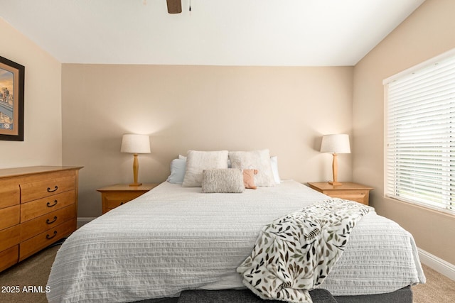 carpeted bedroom with a ceiling fan and baseboards