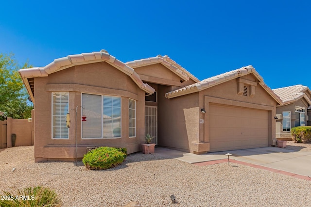 ranch-style home with stucco siding, concrete driveway, a tile roof, and a garage