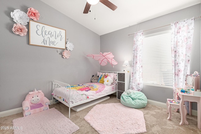 carpeted bedroom with baseboards, a ceiling fan, and vaulted ceiling