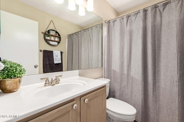 full bathroom with toilet and vanity