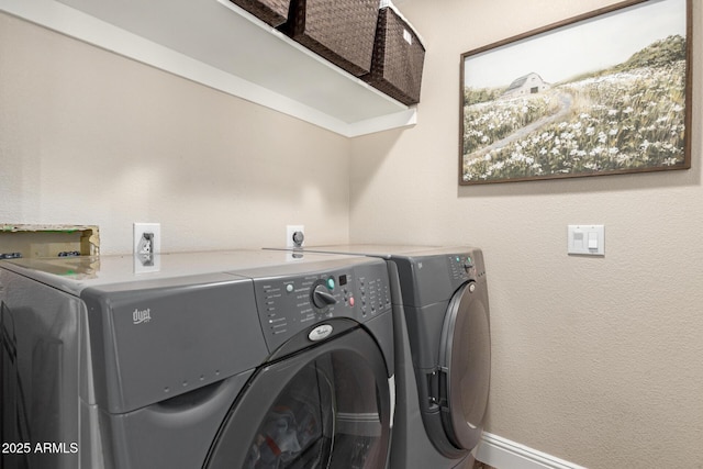 clothes washing area with independent washer and dryer and laundry area