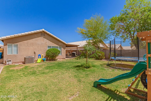 view of yard featuring a playground, a trampoline, cooling unit, and a fenced backyard