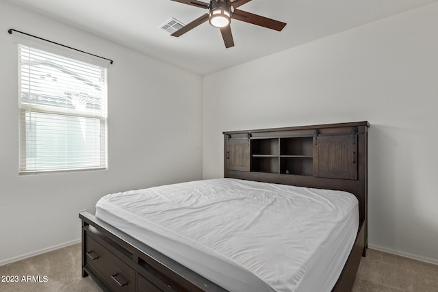 carpeted bedroom with ceiling fan