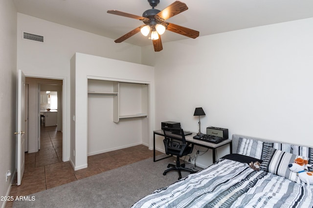 tiled bedroom with visible vents, a closet, baseboards, and ceiling fan