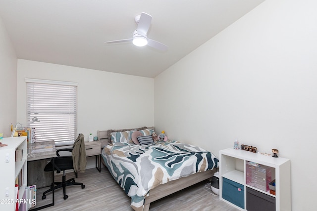bedroom featuring light wood-style floors, ceiling fan, and baseboards