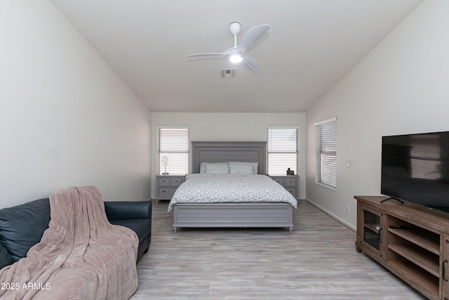 bedroom featuring visible vents, ceiling fan, light wood-type flooring, and lofted ceiling