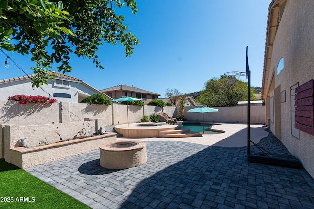 view of patio / terrace featuring an outdoor fire pit, a fenced backyard, a fenced in pool, and an in ground hot tub