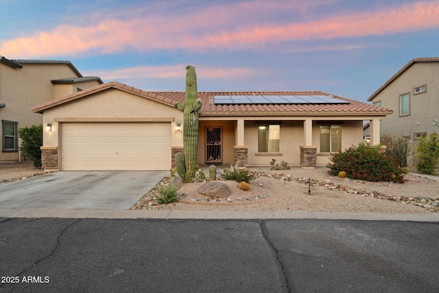 2487 S Conestoga Rd, Apache Junction, AZ 85119 - view of front of house with covered porch, stucco siding, a tiled roof, and concrete driveway