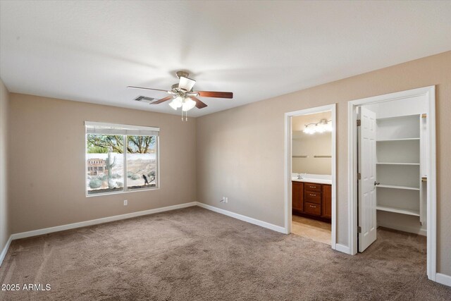2487 S Conestoga Rd, Apache Junction, AZ 85119 - unfurnished bedroom with light colored carpet, a walk in closet, a closet, and ensuite bathroom