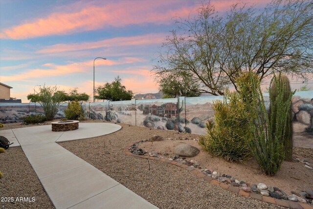 2487 S Conestoga Rd, Apache Junction, AZ 85119 - yard at dusk featuring a fire pit and a patio