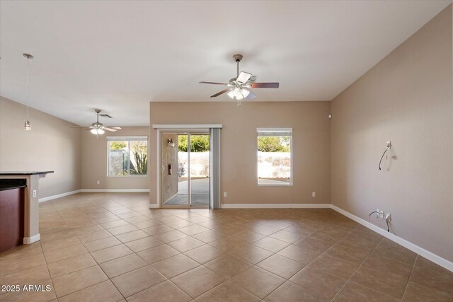 2487 S Conestoga Rd, Apache Junction, AZ 85119 - empty room featuring a ceiling fan, plenty of natural light, and light tile patterned floors