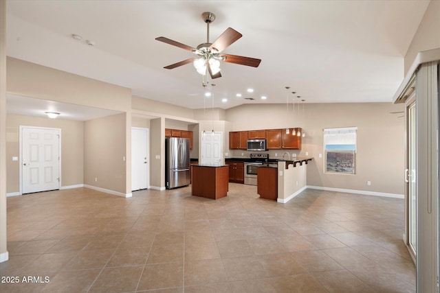 2487 S Conestoga Rd, Apache Junction, AZ 85119 - kitchen with appliances with stainless steel finishes, open floor plan, dark countertops, a center island, and light tile patterned floors