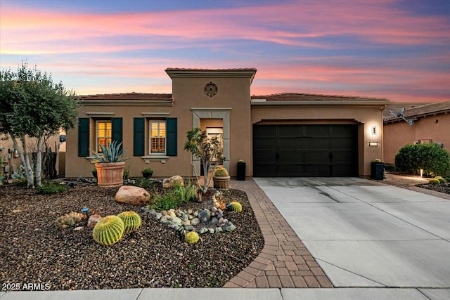 mediterranean / spanish-style home with a garage