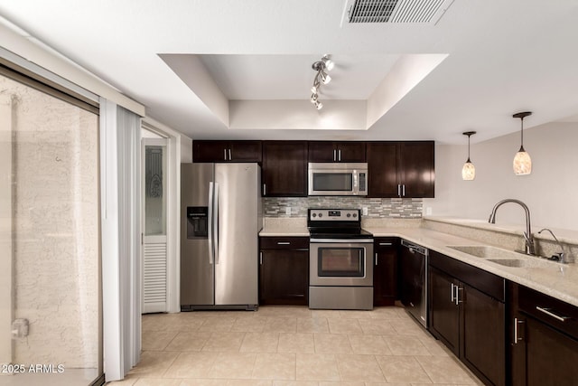 19601 N 7th St Unit 1022, Phoenix, AZ 85024 - kitchen with appliances with stainless steel finishes, dark brown cabinetry, a raised ceiling, and light countertops