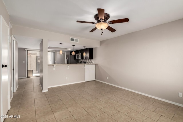 19601 N 7th St Unit 1022, Phoenix, AZ 85024 - kitchen featuring stainless steel appliances, a ceiling fan, light tile patterned flooring, a peninsula, and pendant lighting