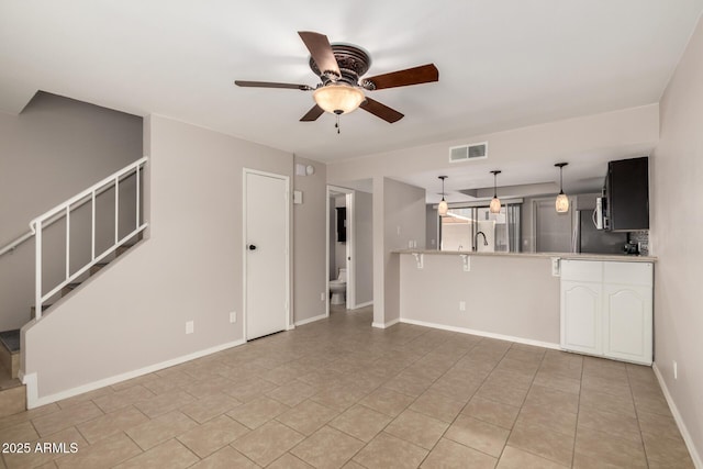 19601 N 7th St Unit 1022, Phoenix, AZ 85024 - unfurnished living room featuring a ceiling fan, stairs, and light tile patterned flooring
