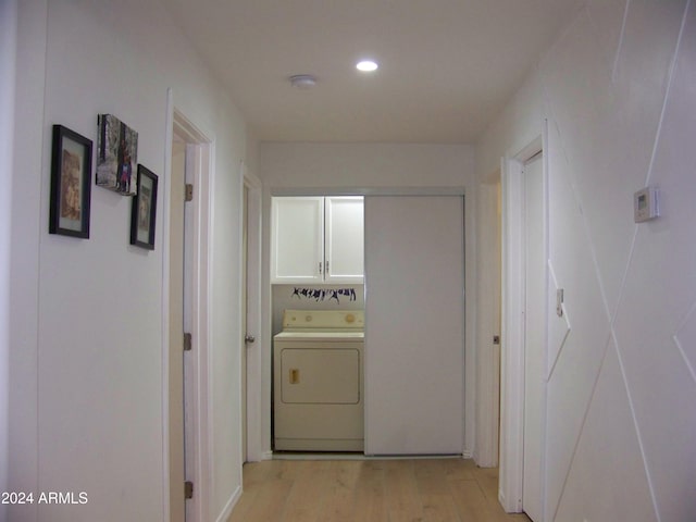 hallway with light hardwood / wood-style floors and washer / dryer