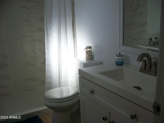 bathroom with tile patterned flooring, vanity, toilet, and walk in shower