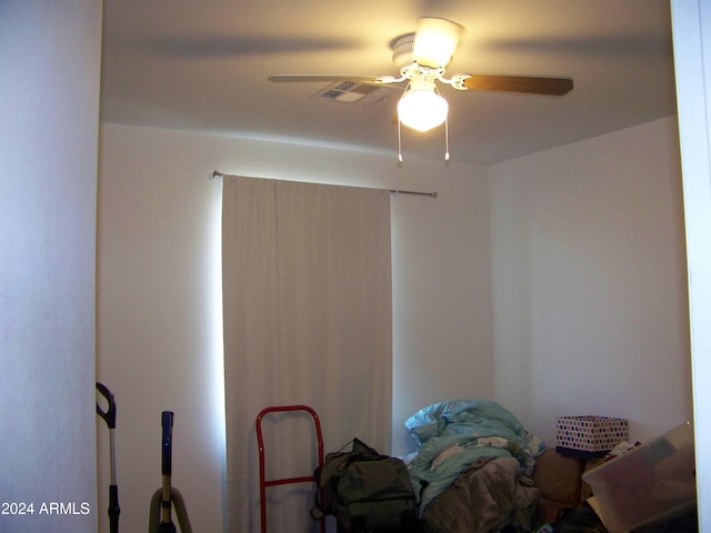 interior space with ceiling fan