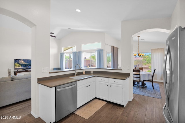 4611 E Night Glow Dr, Cave Creek, AZ 85331 - kitchen featuring appliances with stainless steel finishes, a sink, lofted ceiling, arched walkways, and dark countertops