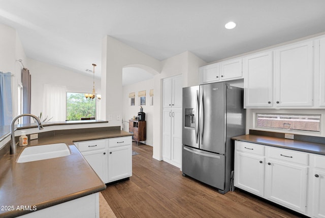4611 E Night Glow Dr, Cave Creek, AZ 85331 - kitchen with stainless steel fridge, a sink, dark countertops, white cabinetry, and lofted ceiling