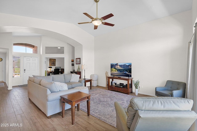 4611 E Night Glow Dr, Cave Creek, AZ 85331 - living room with arched walkways, a ceiling fan, light wood finished floors, high vaulted ceiling, and a desk