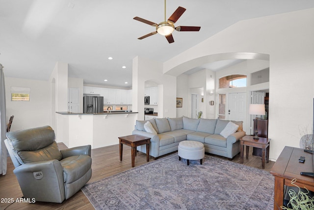 4611 E Night Glow Dr, Cave Creek, AZ 85331 - living room featuring arched walkways, ceiling fan, wood finished floors, lofted ceiling, and recessed lighting