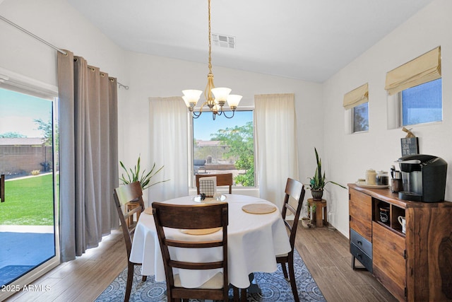 4611 E Night Glow Dr, Cave Creek, AZ 85331 - dining area with a chandelier, wood finished floors, and vaulted ceiling