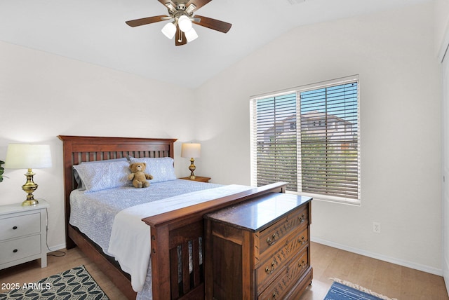 4611 E Night Glow Dr, Cave Creek, AZ 85331 - bedroom with multiple windows, lofted ceiling, light wood-style flooring, baseboards, and a ceiling fan