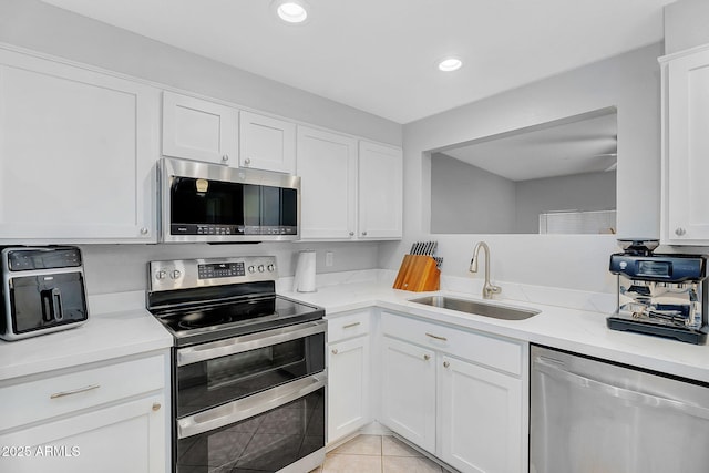 1511 W Mesquite St, Chandler, AZ 85224 - kitchen with recessed lighting, white cabinetry, a sink, light tile patterned floors, and stainless steel appliances
