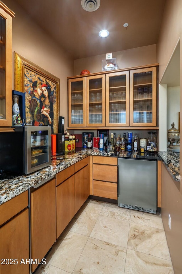 kitchen with fridge and dark stone counters