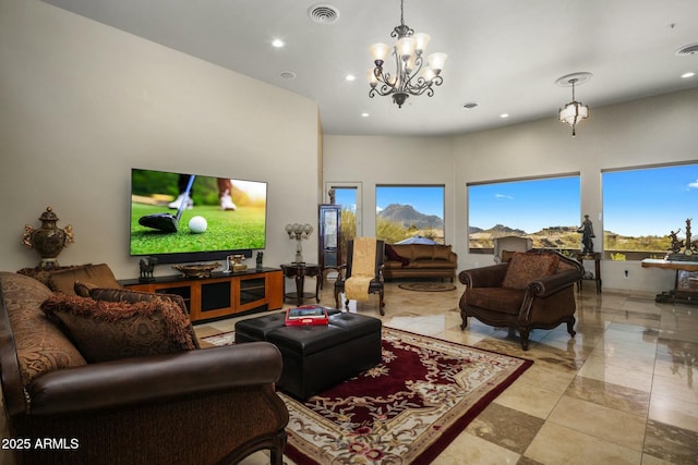 living room featuring a towering ceiling and a chandelier