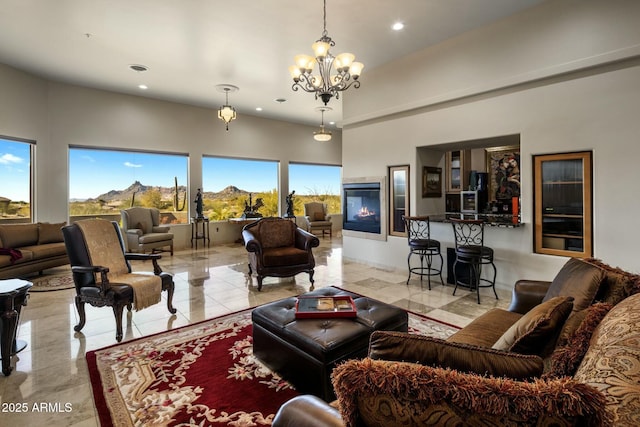 living room featuring an inviting chandelier and a towering ceiling