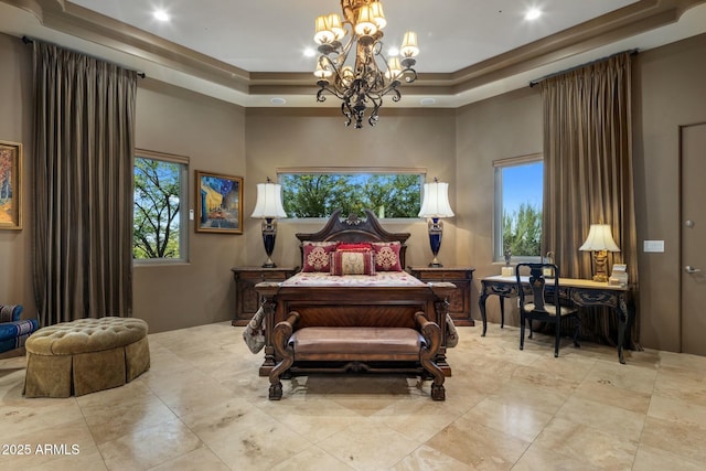 bedroom with a raised ceiling, a towering ceiling, and a chandelier