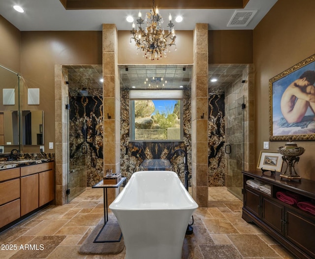 bathroom featuring vanity, plus walk in shower, and a chandelier