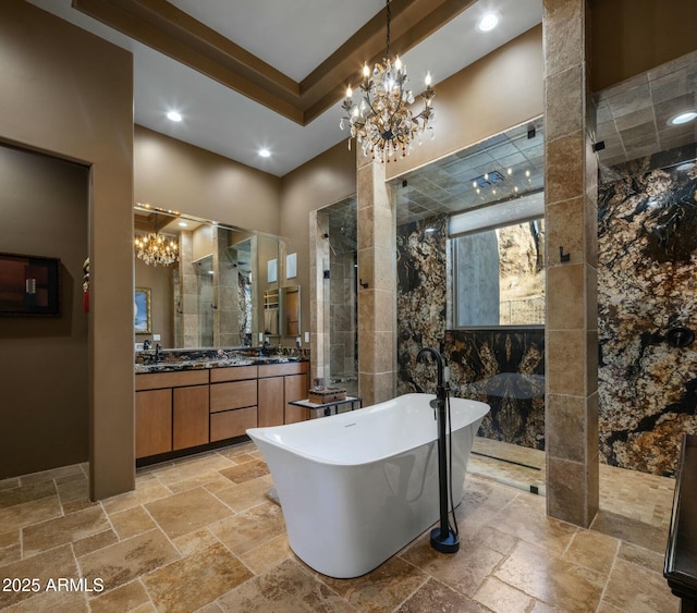 bathroom featuring vanity, a notable chandelier, and independent shower and bath