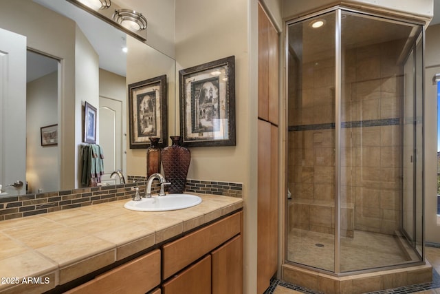 bathroom featuring vanity and a shower with door