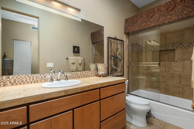 full bathroom with vanity, combined bath / shower with glass door, and toilet