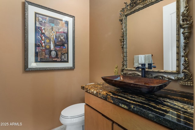 bathroom featuring vanity and toilet