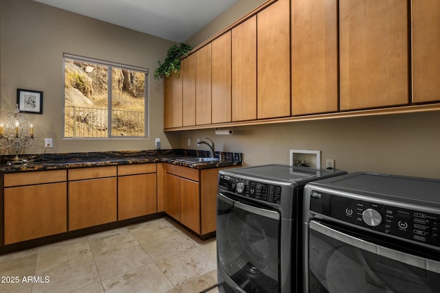 clothes washing area with cabinets, independent washer and dryer, and sink