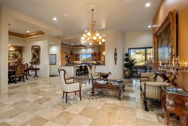 living room with a notable chandelier and a tray ceiling