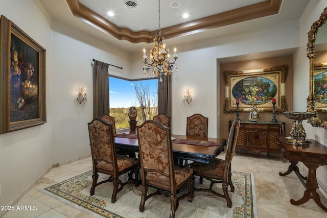 tiled dining room featuring a notable chandelier and a tray ceiling