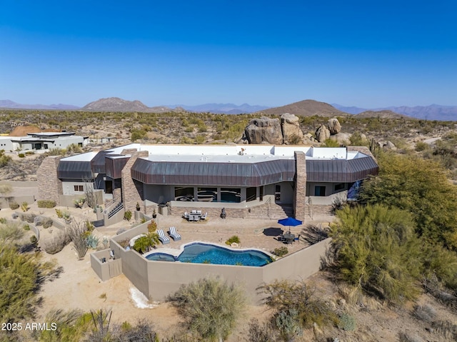 back of property featuring a mountain view