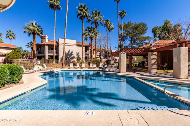 community pool featuring a patio area, fence, and a pergola