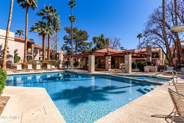 community pool with a patio, fence, and a pergola