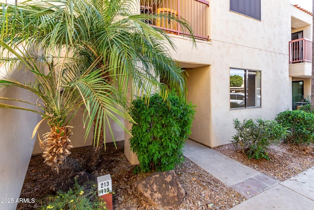 entrance to property featuring stucco siding